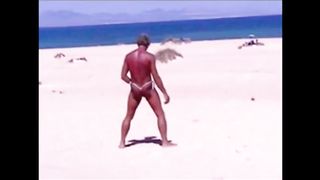 Tanned guy on beach in tiny string thong (temporarily!)